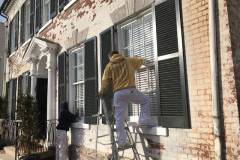 Working on Windows in Exterior of Old Town Alexandria Business