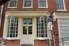Windows of Historic Alexandria Building Being Prepped for Painting and Restoration